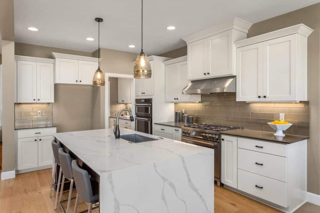 Kitchen in new luxury home with waterfall isalnd, stainless stee